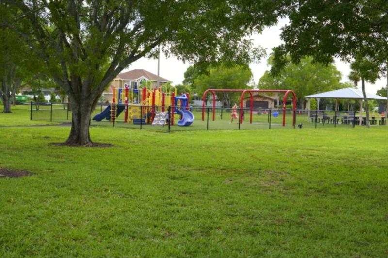 A shady Cape Coral park with a playground